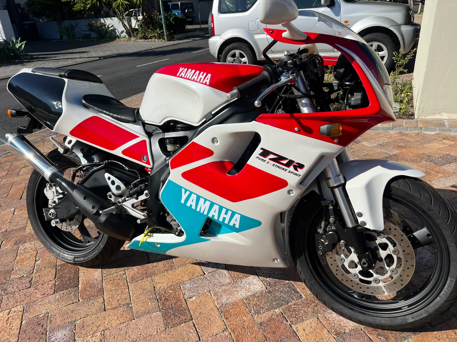 Red and white Yamaha TZR two-stroke motorcycle