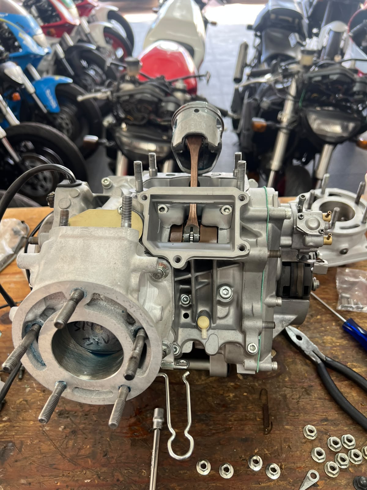 Bottom end rebuild — piston and crankcase on the bench